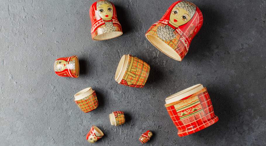 A red matryoshka doll on a black background Traditional Russian toy