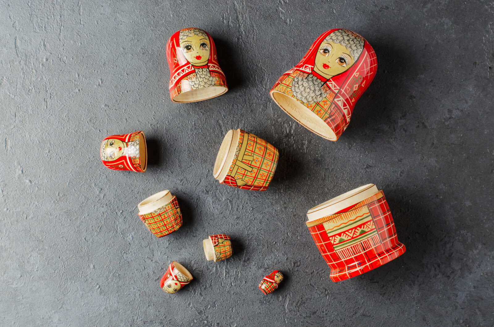 A red matryoshka doll on a black background Traditional Russian toy