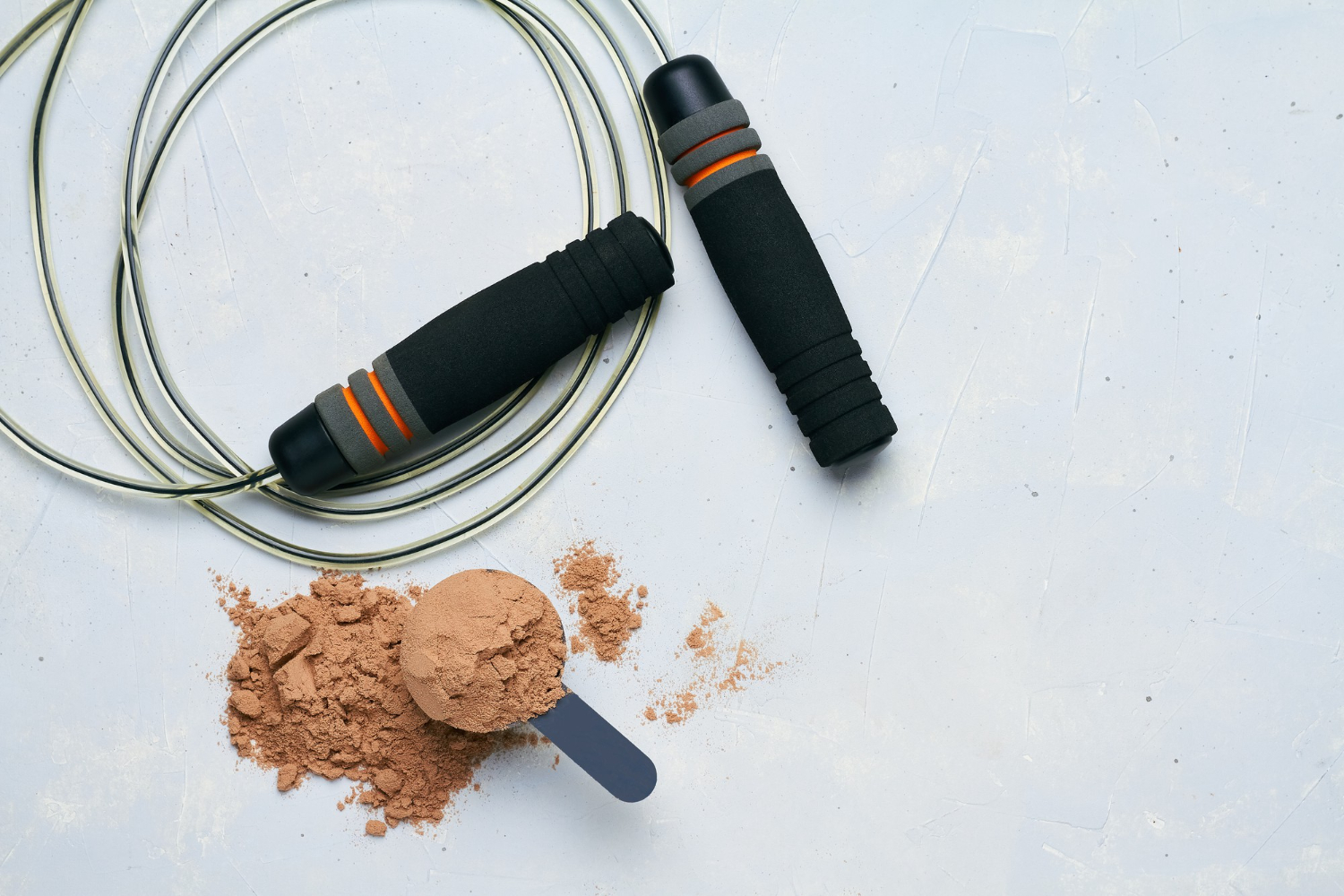 scoop protein powder and a jumping rope with meal plan