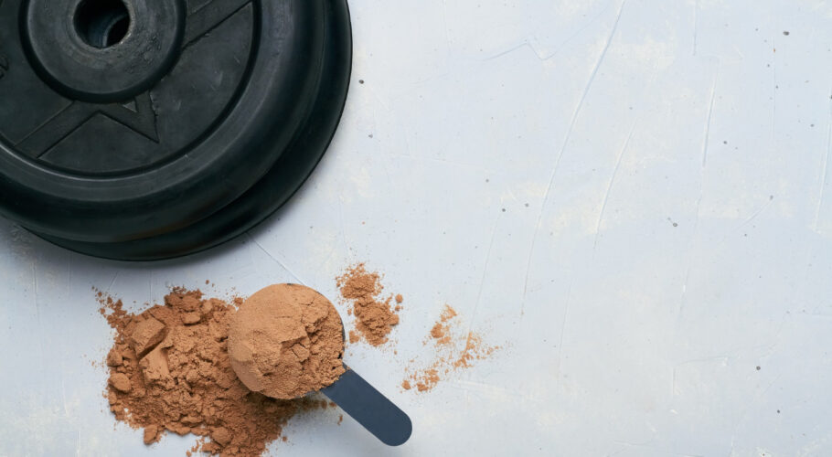 scoop of protein powder and weight plates