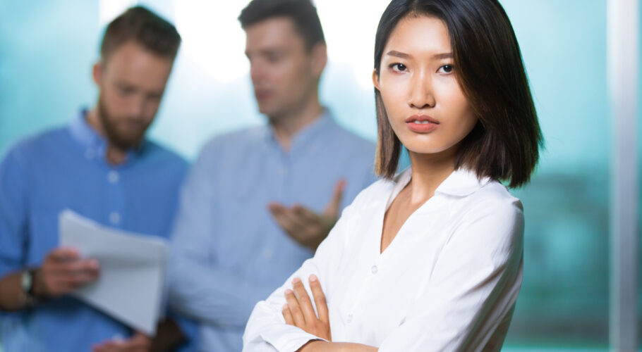 serious confident asian lady boss crossing arms