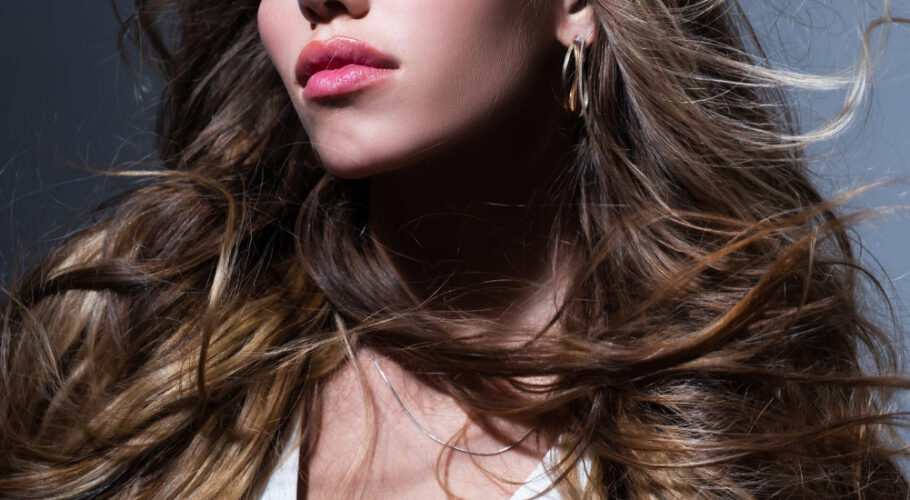 sexy girl with long shiny wavy hair beautiful woman model with curly hairstyle