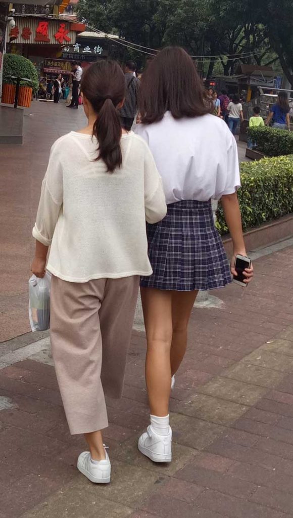 Filial Chinese Girl Hand In Hand With Her Chinese Mother
