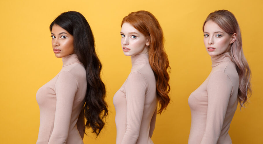 side view of three young serious ladies in newspaper