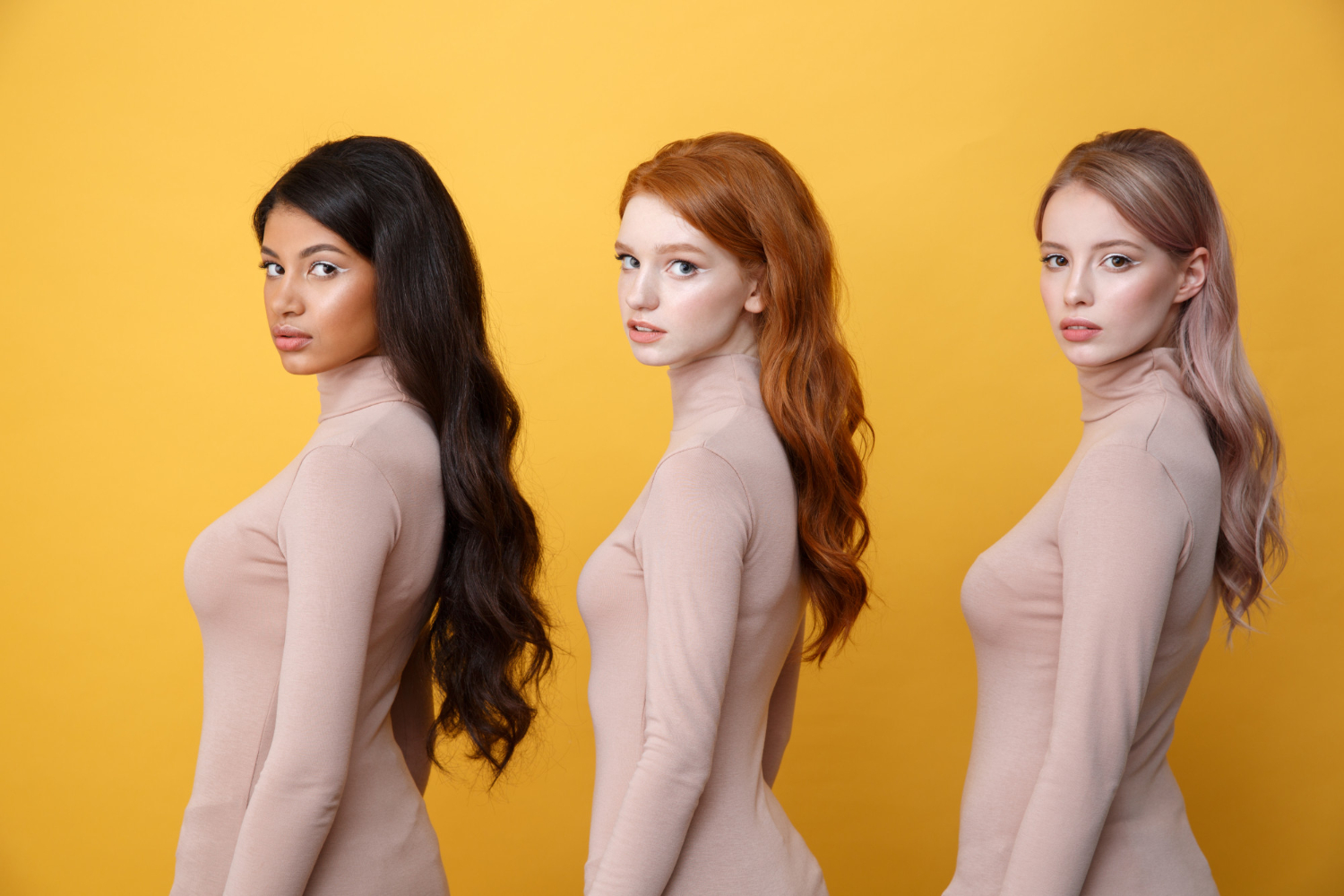 side view of three young serious ladies in newspaper