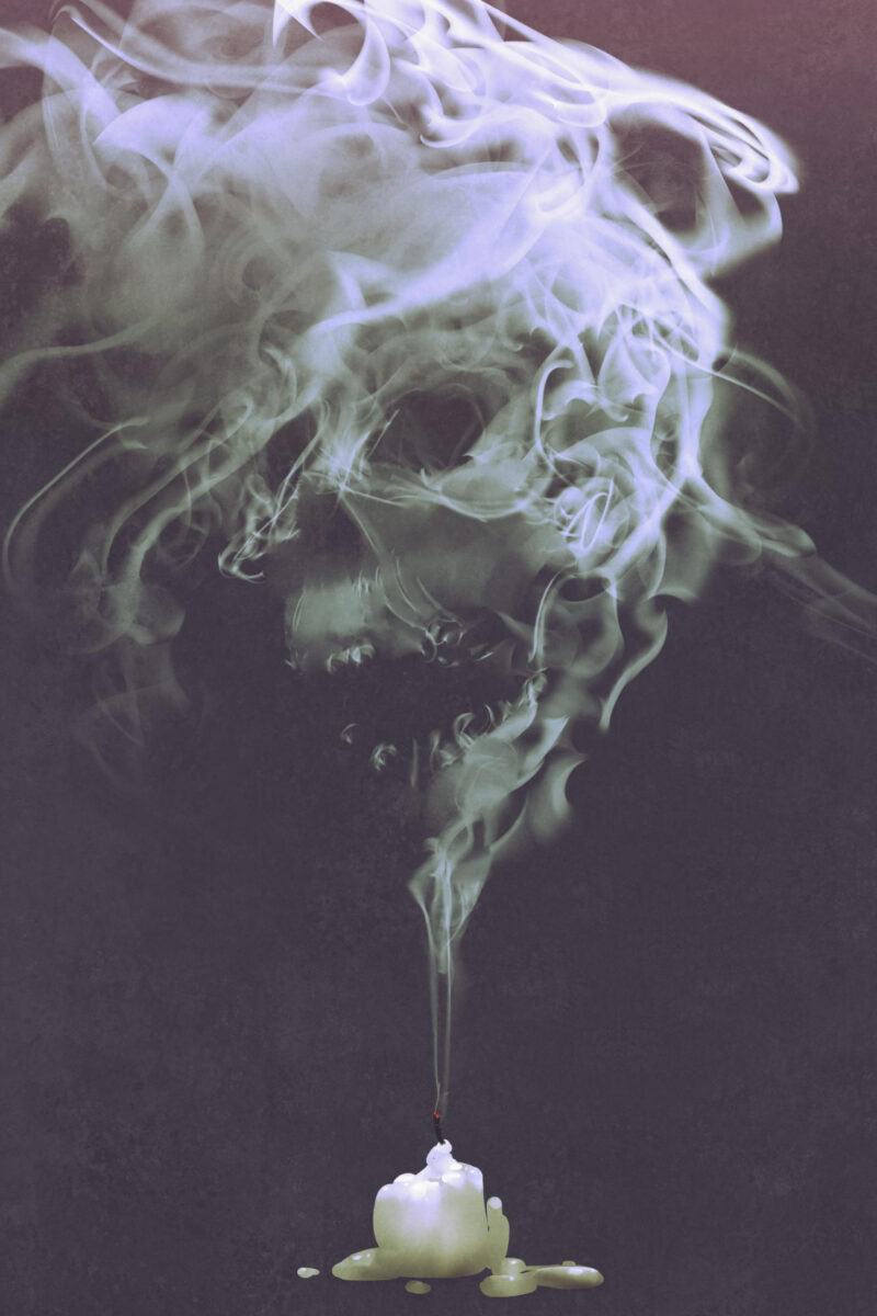 skull shaped smoke comes out from burnt candle