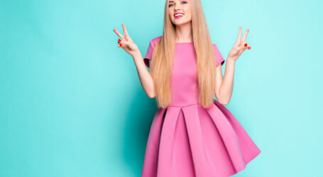 smiling beautiful young woman pink mini dress