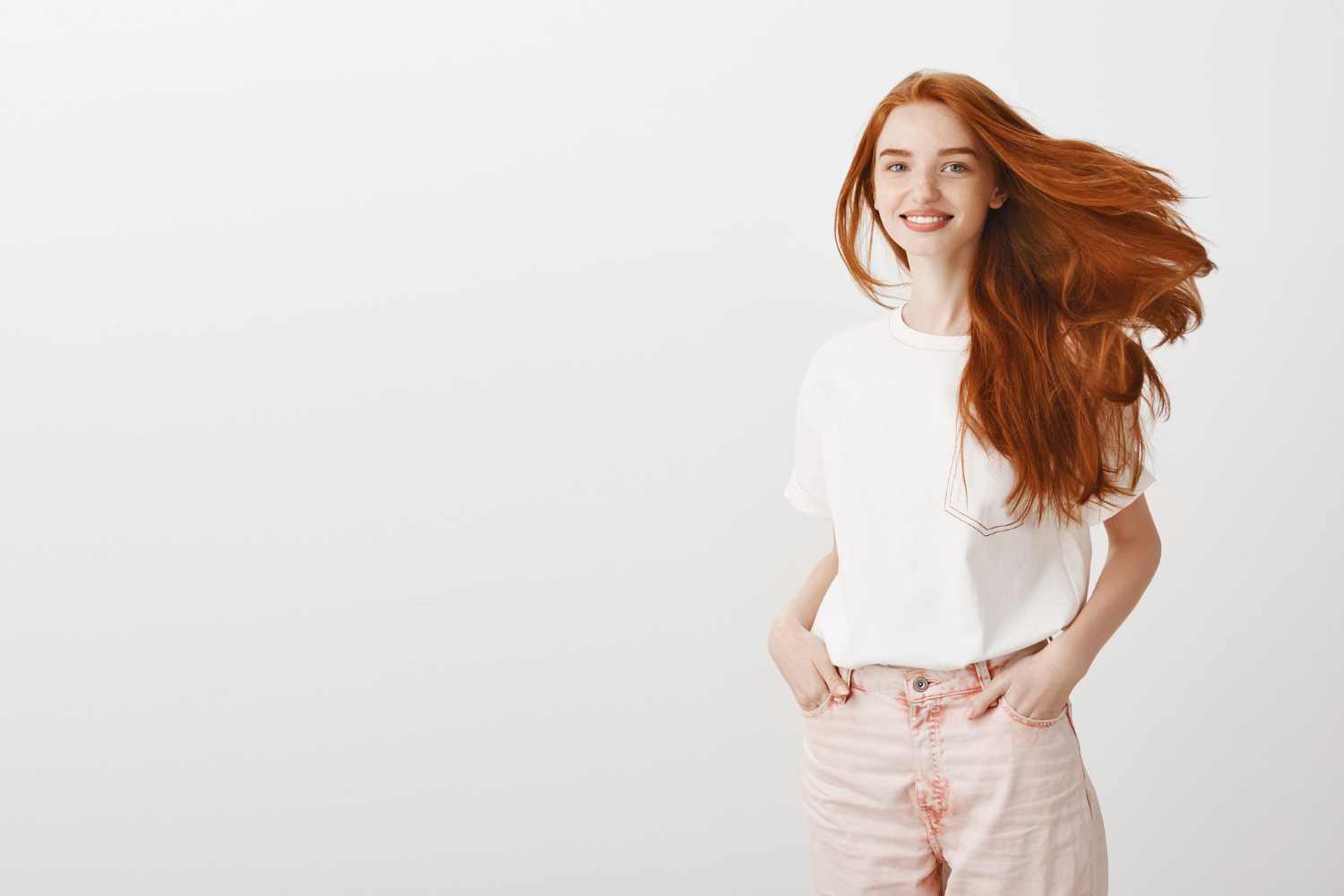 smiling happy attractive redhead girl shaking head enjoying new haircut