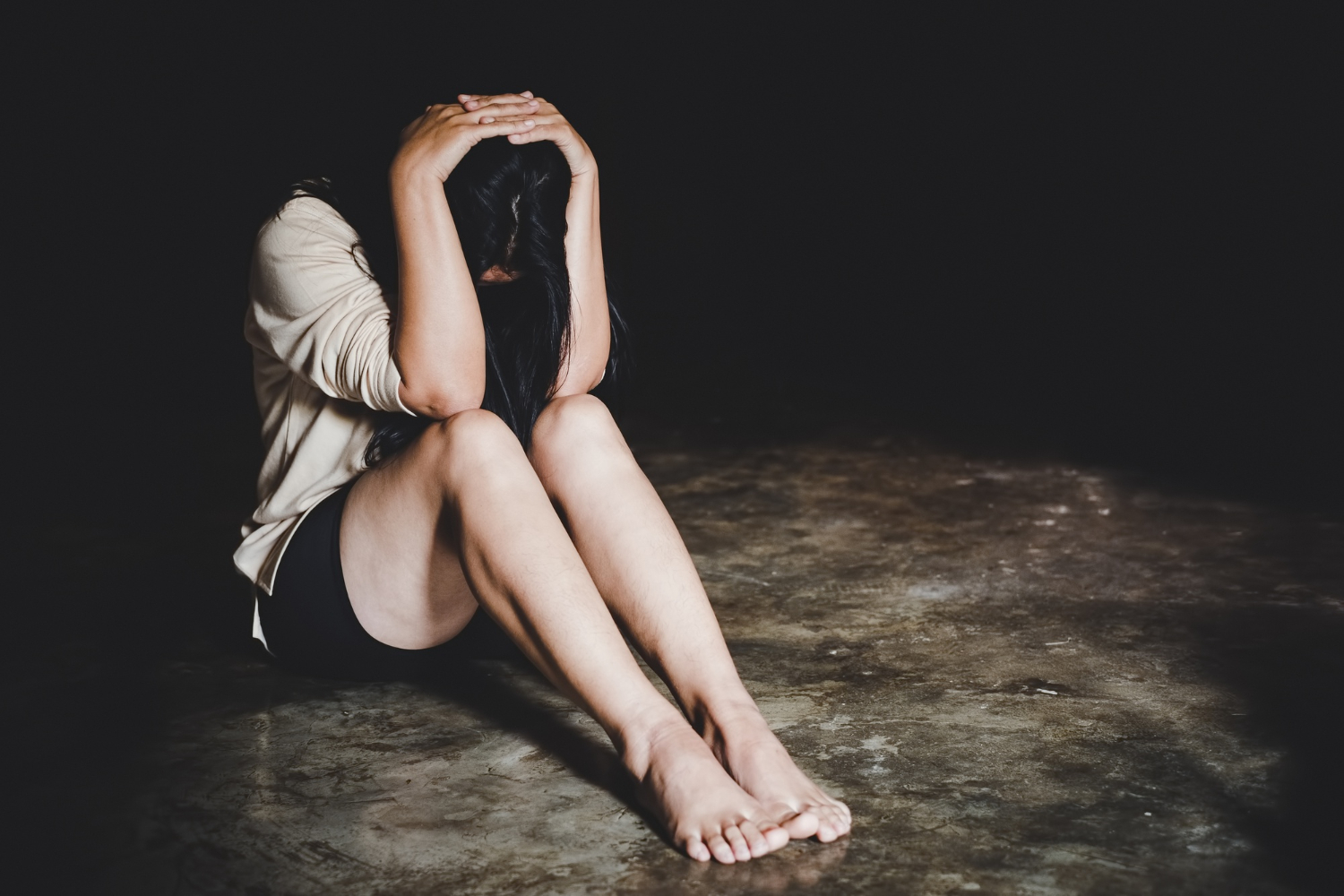 woman post rape seated on floor distraught