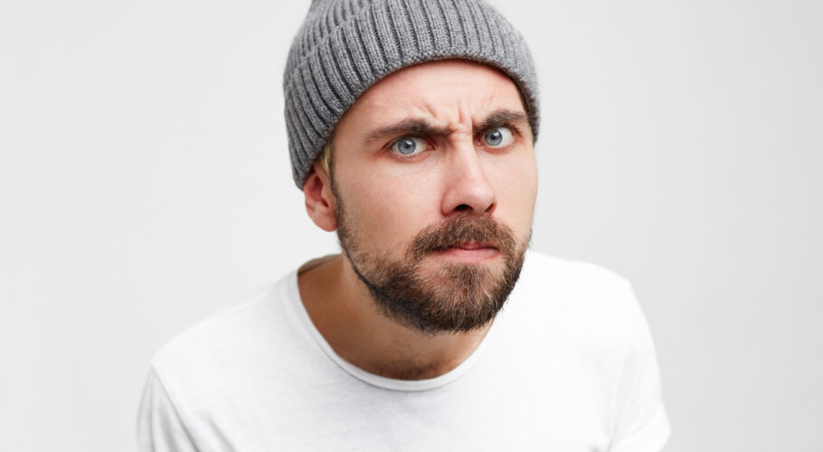 young man as if looking into peephole with interest shrill meticulously