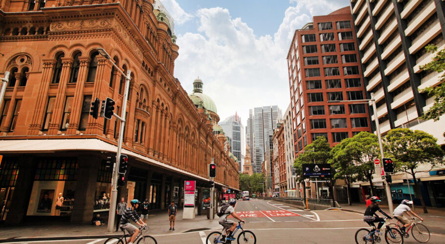 sydney australia cyclists drive along queen victoria building qvb