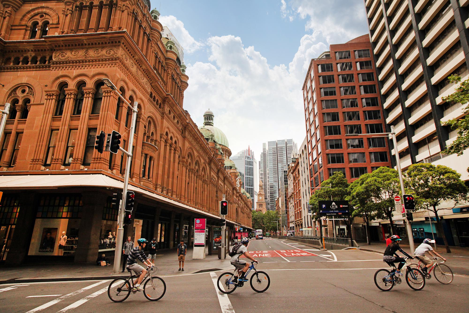 sydney australia cyclists drive along queen victoria building qvb