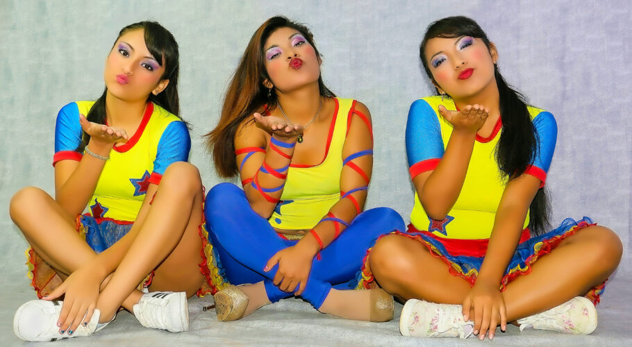 three girls dressed as cheerleaders cheerful at dance practice