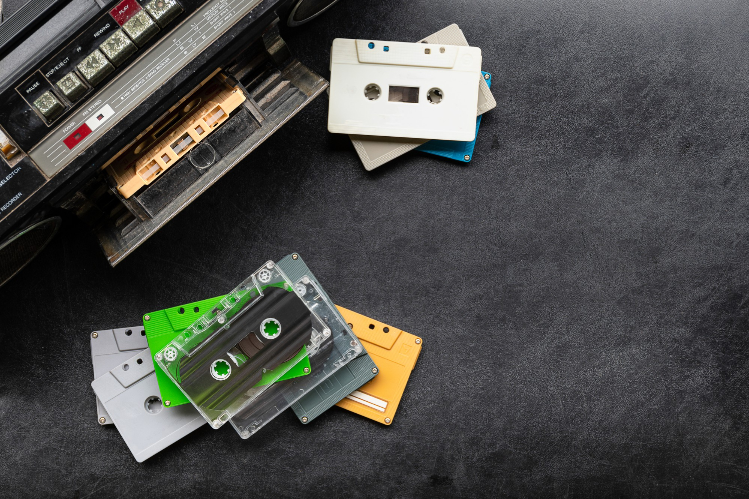 top view retro radio colorful cassette tape black floor