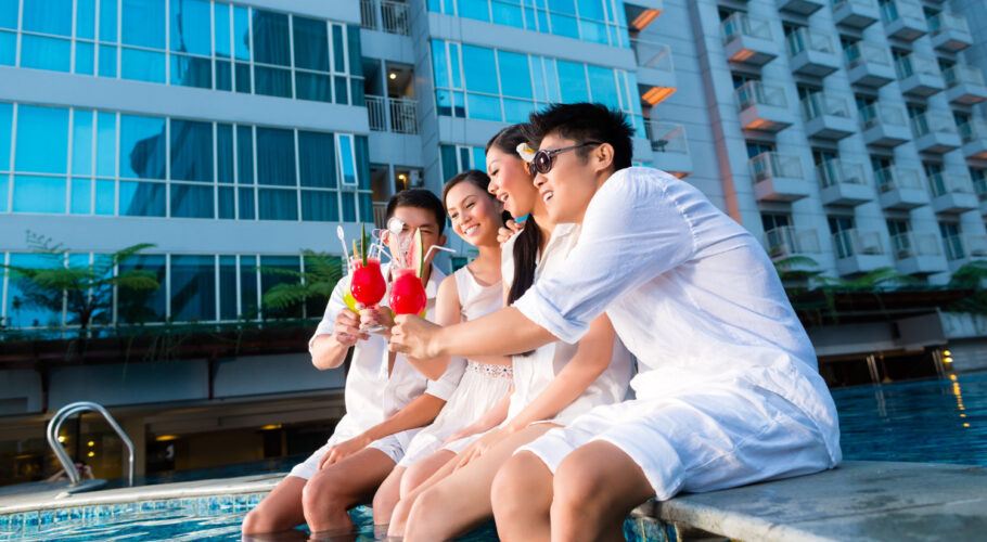 two young handsome asian chinese couples friends drinking cocktails luxurious fancy hotel pool bar