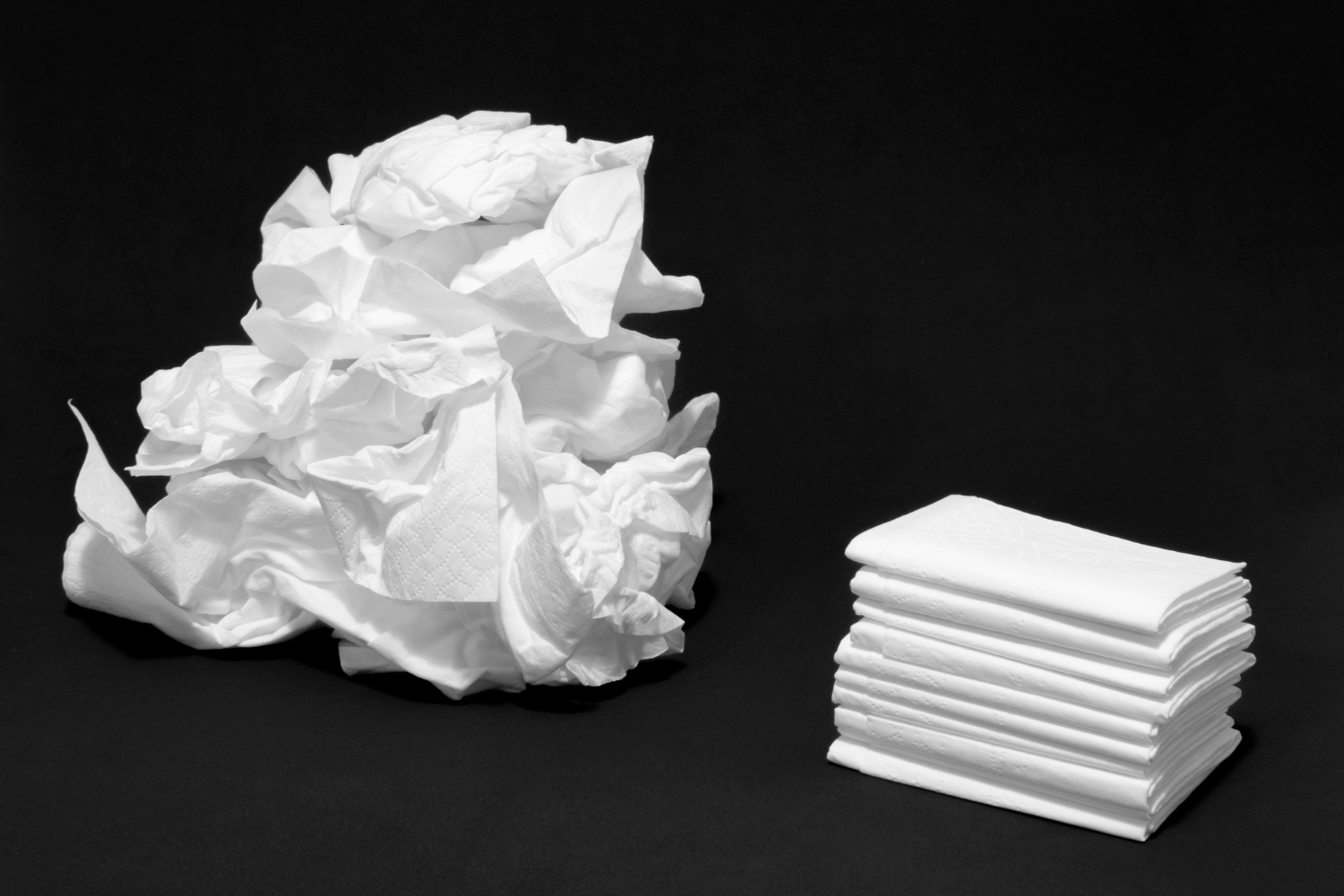 used and new tissues crumpled up by sick person with cold or flu