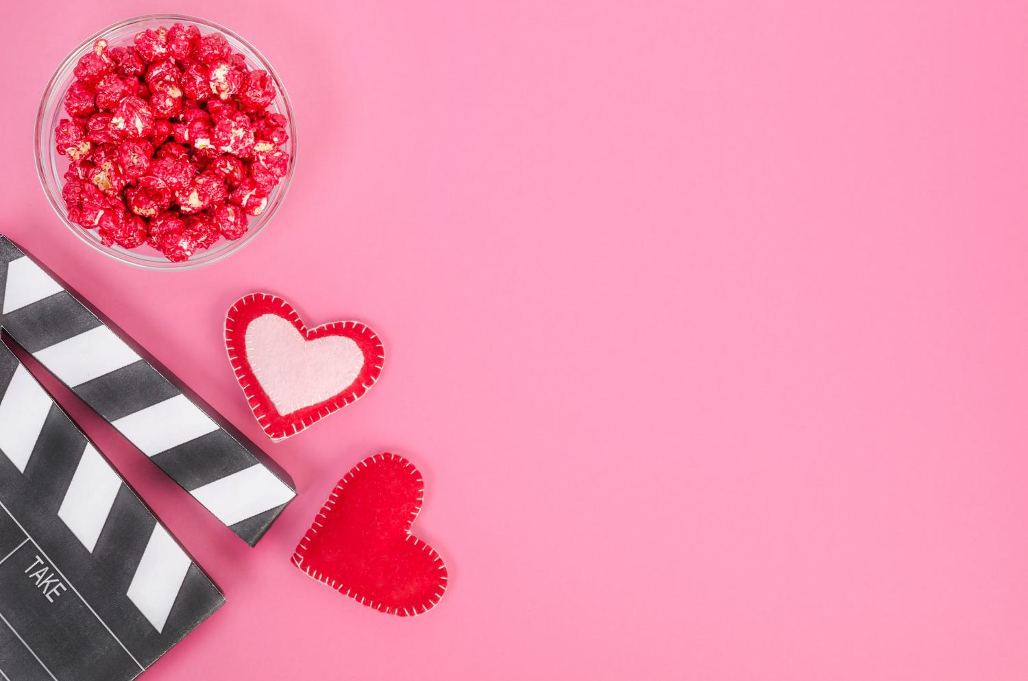 valentines day movie concept movie clapperboard with hearts red caramel popcorn with