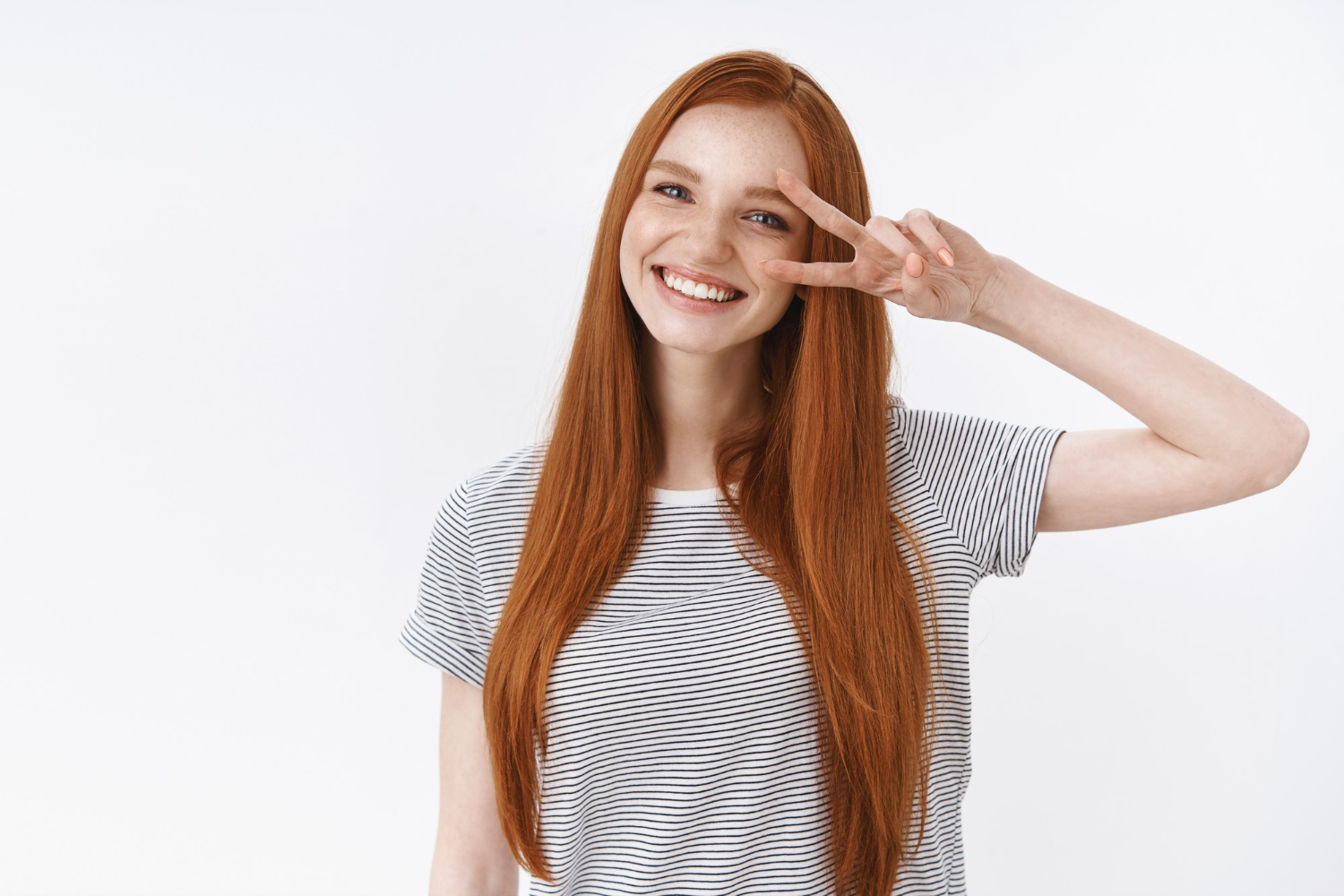 waist up shot friendly kind optimistic attractive young lucky teenage redhead girl blue eyes tilting head