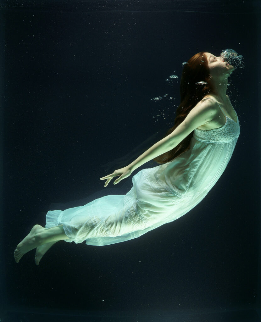 woman diving into water tank