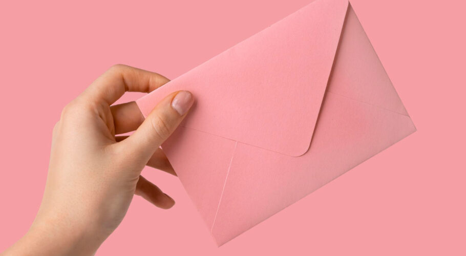 woman hand receiving giving pink envelope with love letter inside lyssa