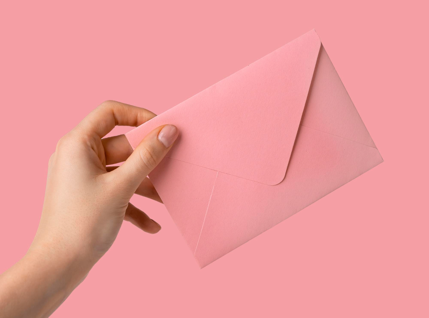 woman hand receiving giving pink envelope with love letter inside lyssa