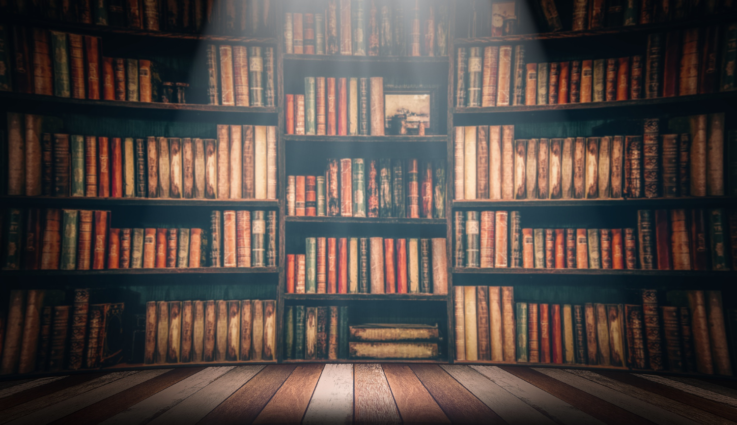 wooden table in a large library full of books and novels