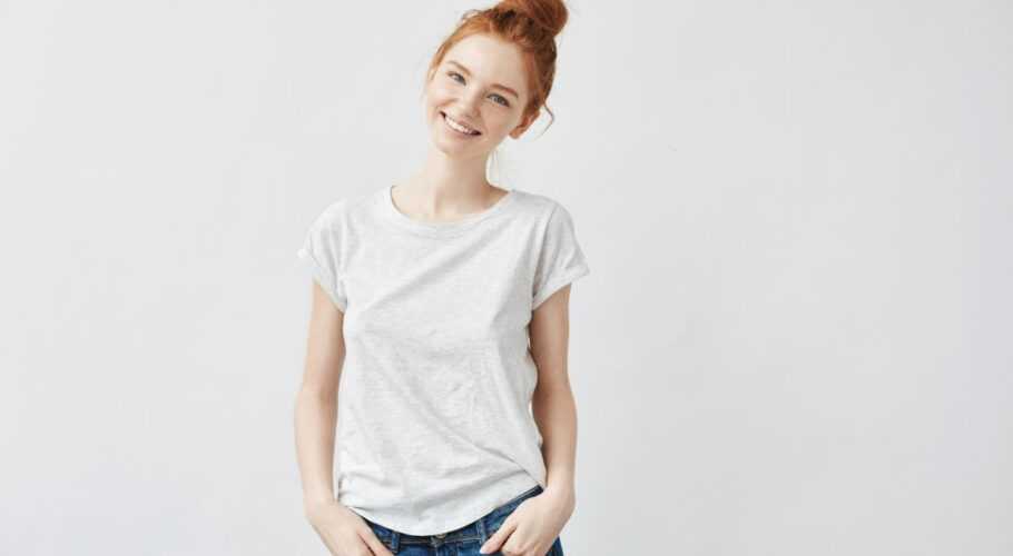 young attractive redhead girl smiling looking camera isolated white