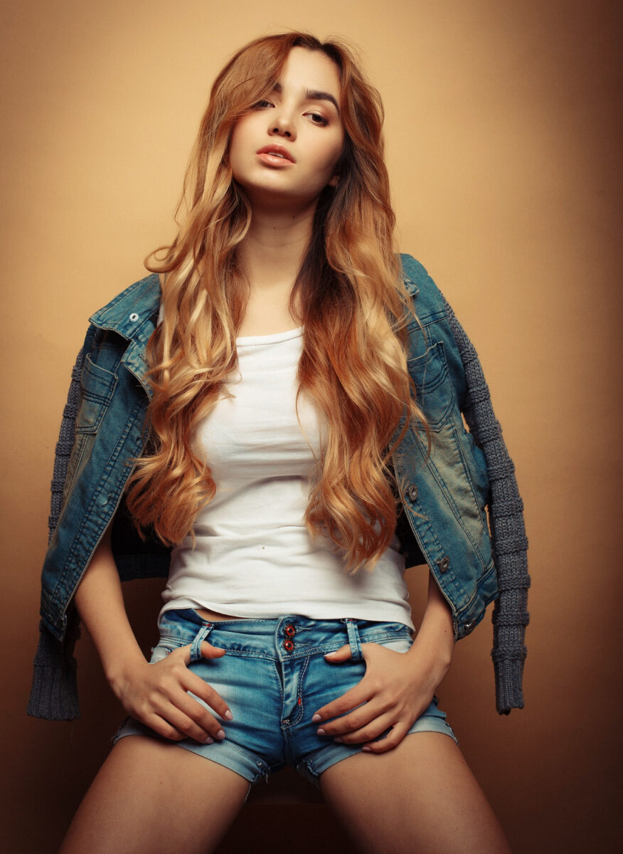 young beautiful curly woman tarina posing with hands on pockets