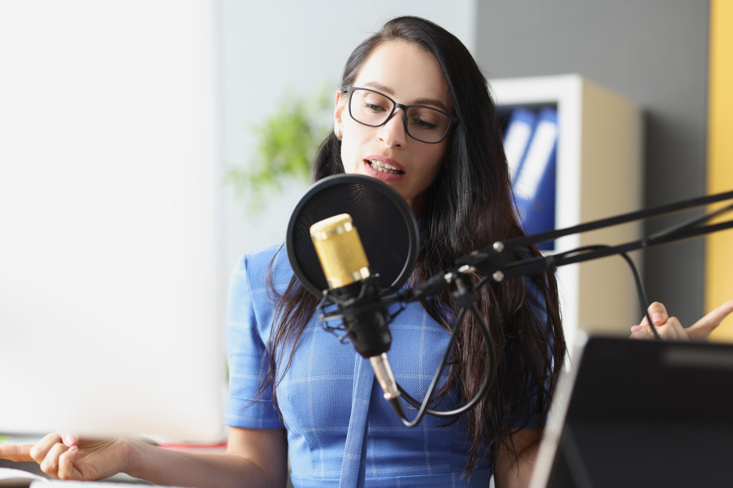 young beautiful woman speaks into microphone workplace work radio host