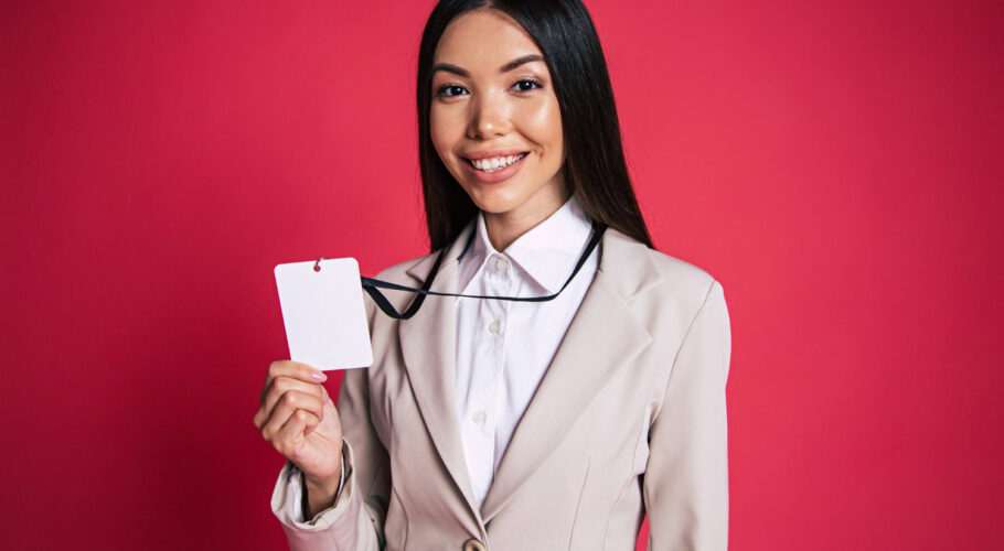 young excited shouting asian business woman suit glasses stands with company access card
