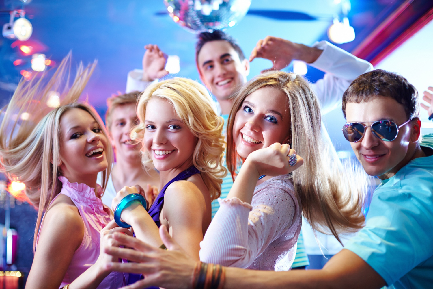 young friends dancing drinking smoking at a house party