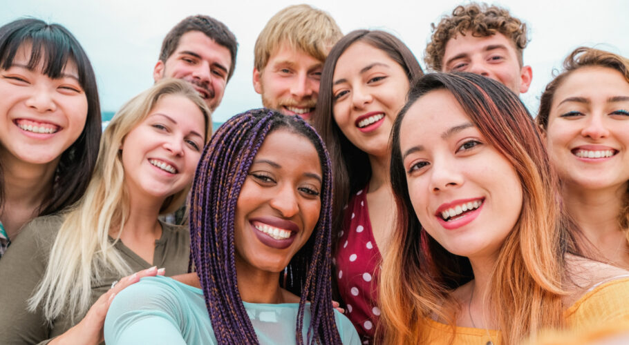 young friends from diverse cultures races taking photo making happy faces friendship together