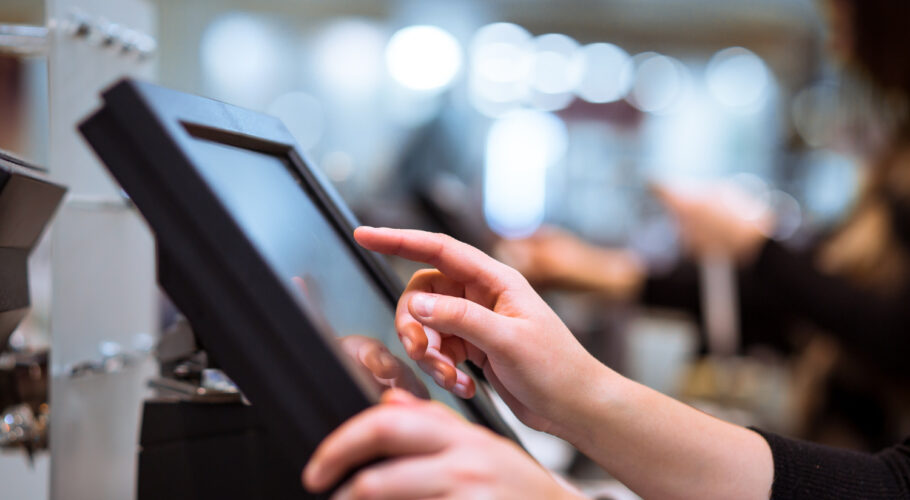 touchscreens kiosk display with young woman doing a job search process
