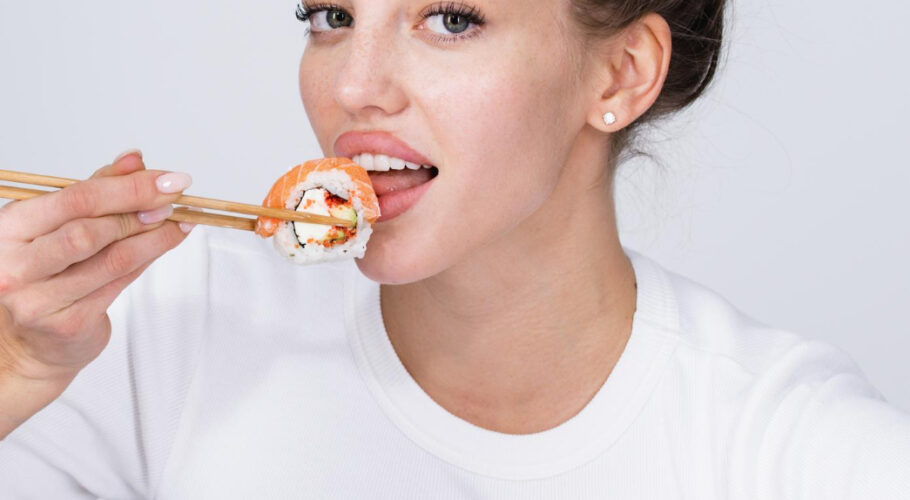 young woman hold hand makizushi sushi roll traditional japanese food lyssa