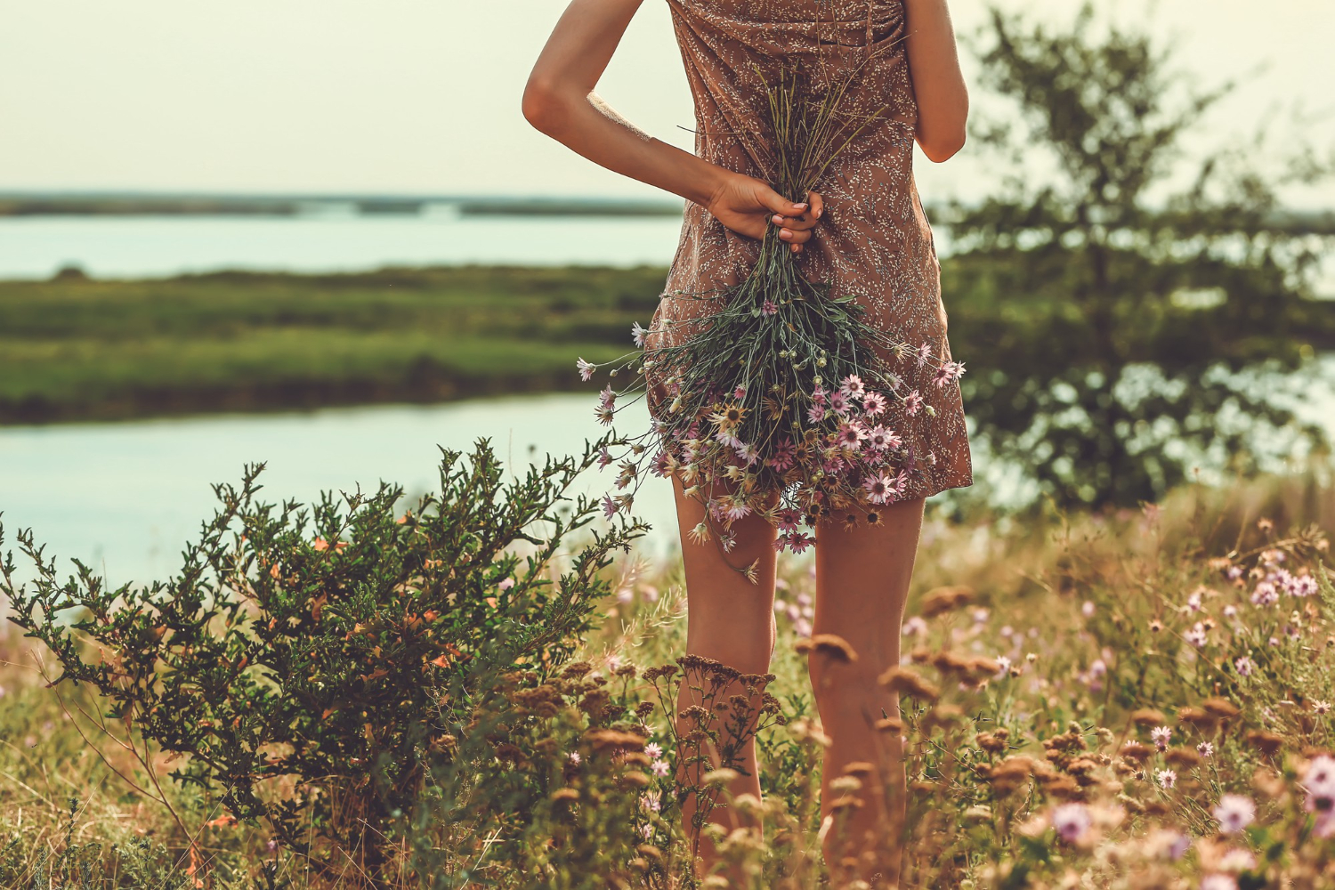 young woman lyssa is standing back holding bouquet flowers nature steppe autumn flowers